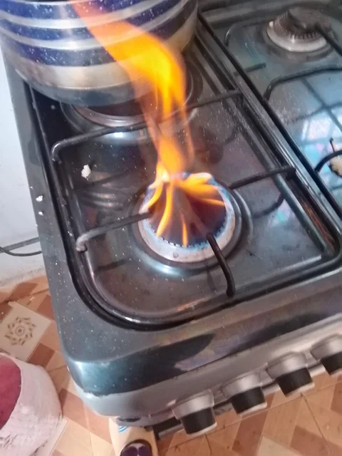 Tall yellow flame from a gas burner that needs cleaning and adjusting