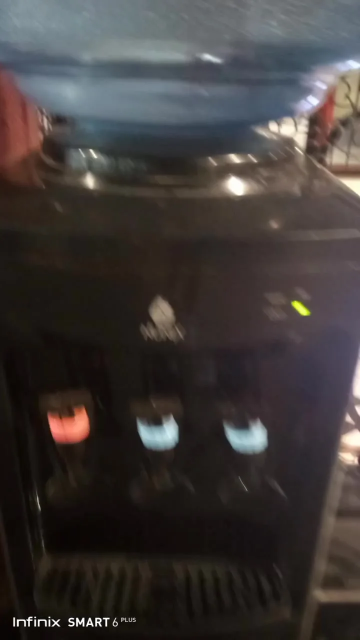 Black three-tap water dispenser with cold and hot lights on