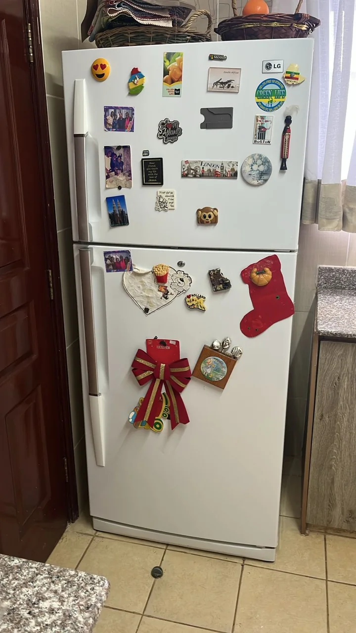 White top-freezer fridge in a customer kitchen