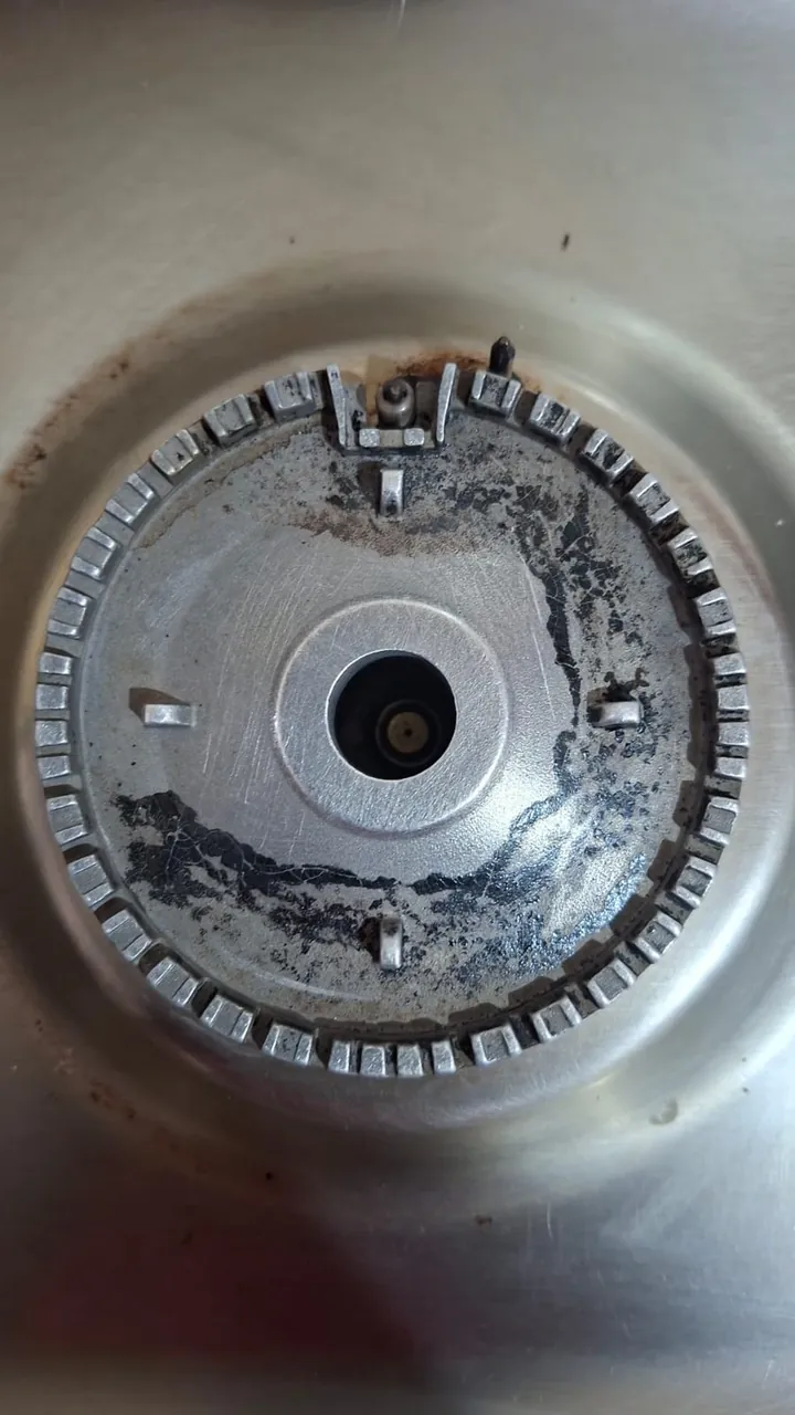 Gas cooker burner base during cleaning