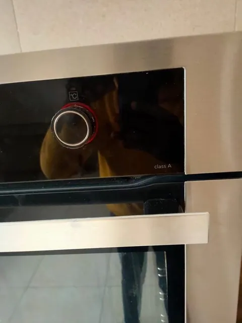 Built-in oven with the door open during a repair visit