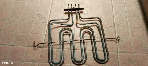Oven grill heating element removed for replacement