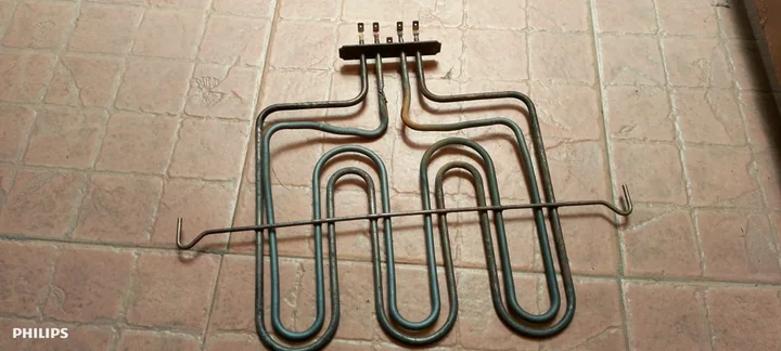 Oven grill heating element removed for replacement