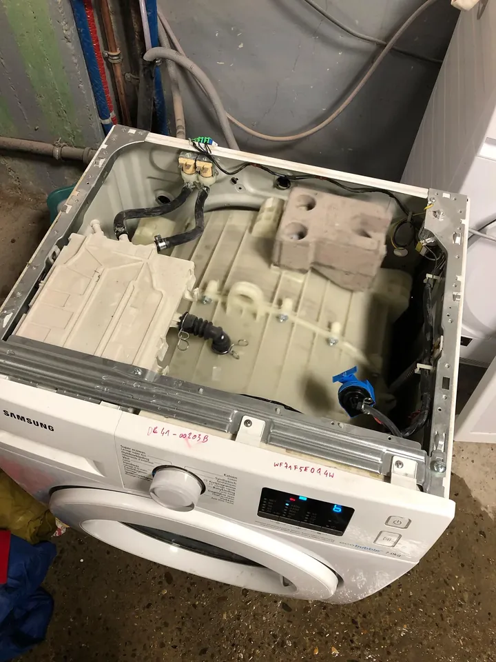 Front-load washing machine opened up during a repair